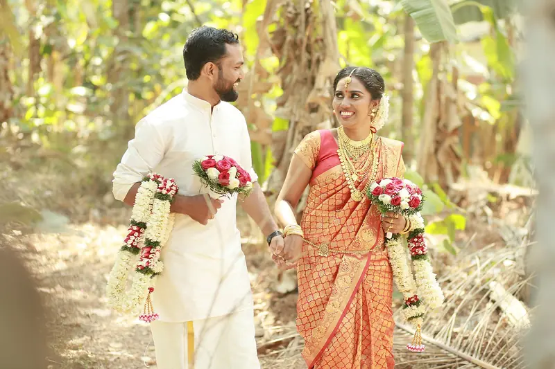 Bride and groom walking together after their wedding ceremony in Kannur district, Kerala